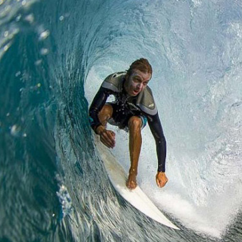 Surfer riding inside a large wave tunnel.
