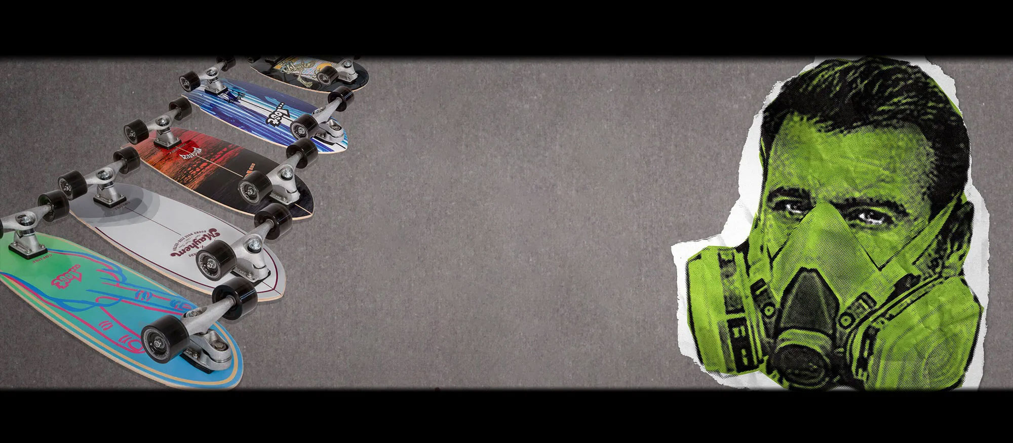 Skateboards arranged in a line with a green masked face.