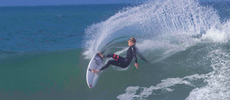 Surfer performing a maneuver on a wave.