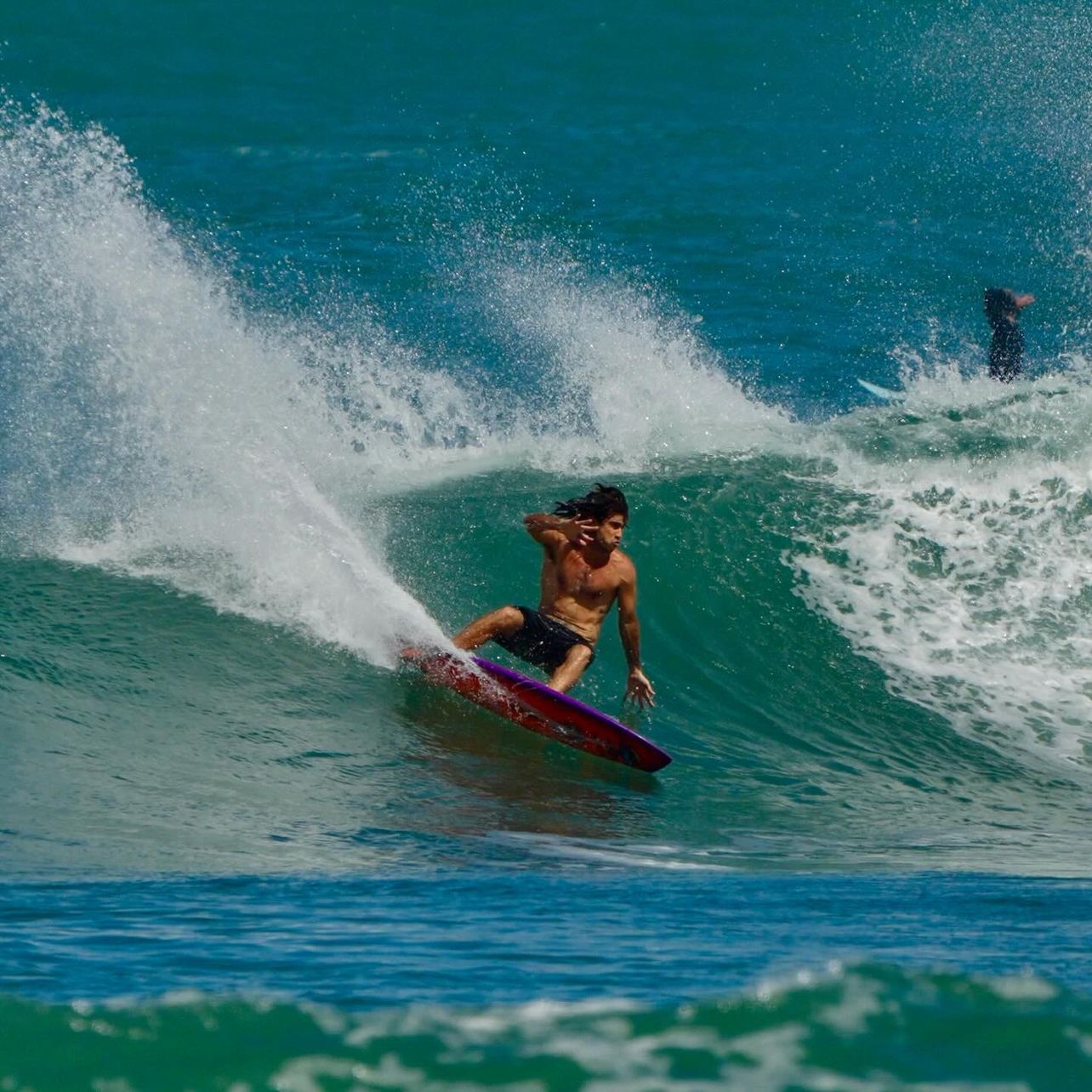 Surfer riding a wave with splashing water.