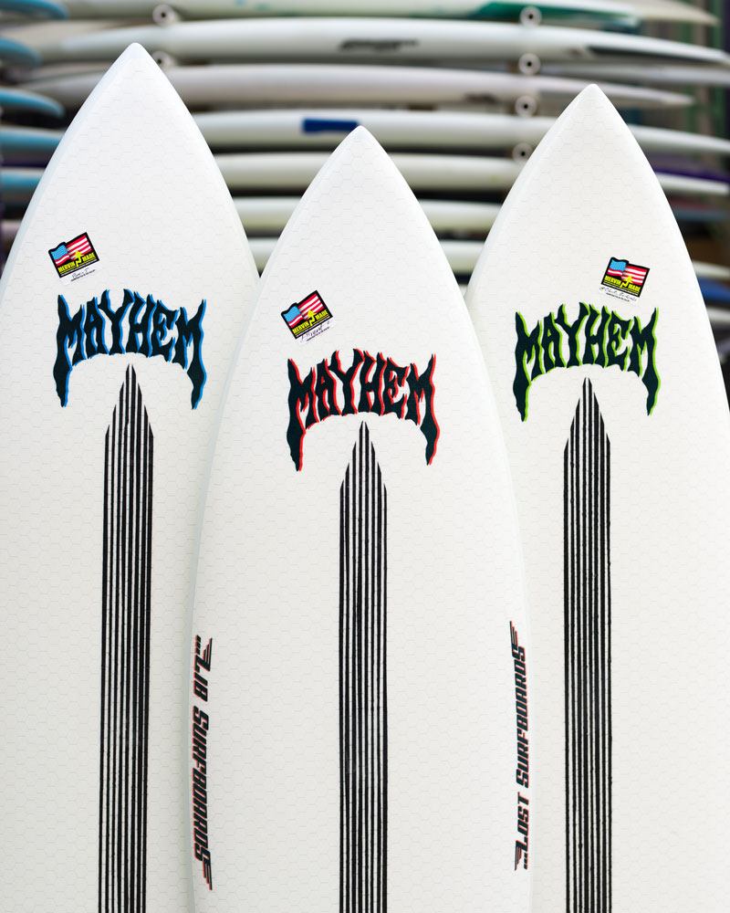 Three surfboards with "MAYHEM" branding and striped designs.