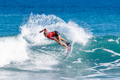 Surfer performing a maneuver on a wave at the championship.