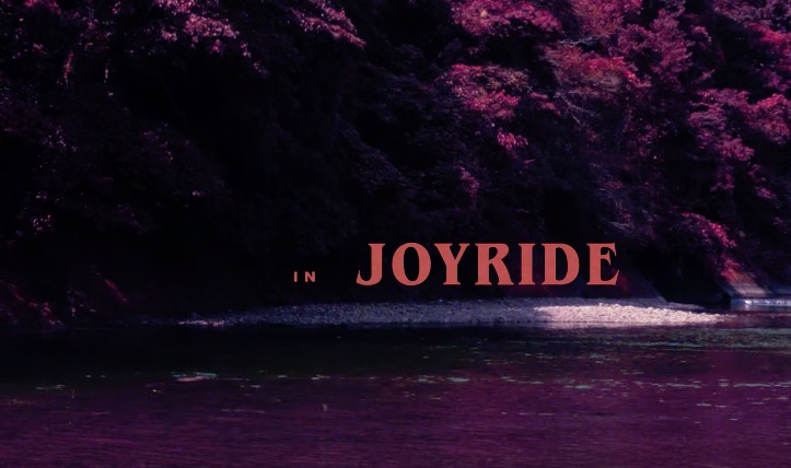 Text overlay "in JOYRIDE" on a purple-toned river scene.