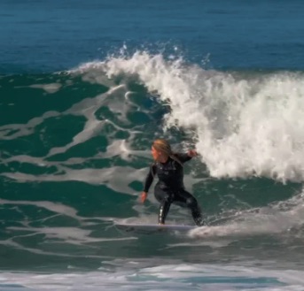 Surfer riding a wave in the ocean.