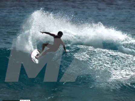 Surfer performing a maneuver on a wave.