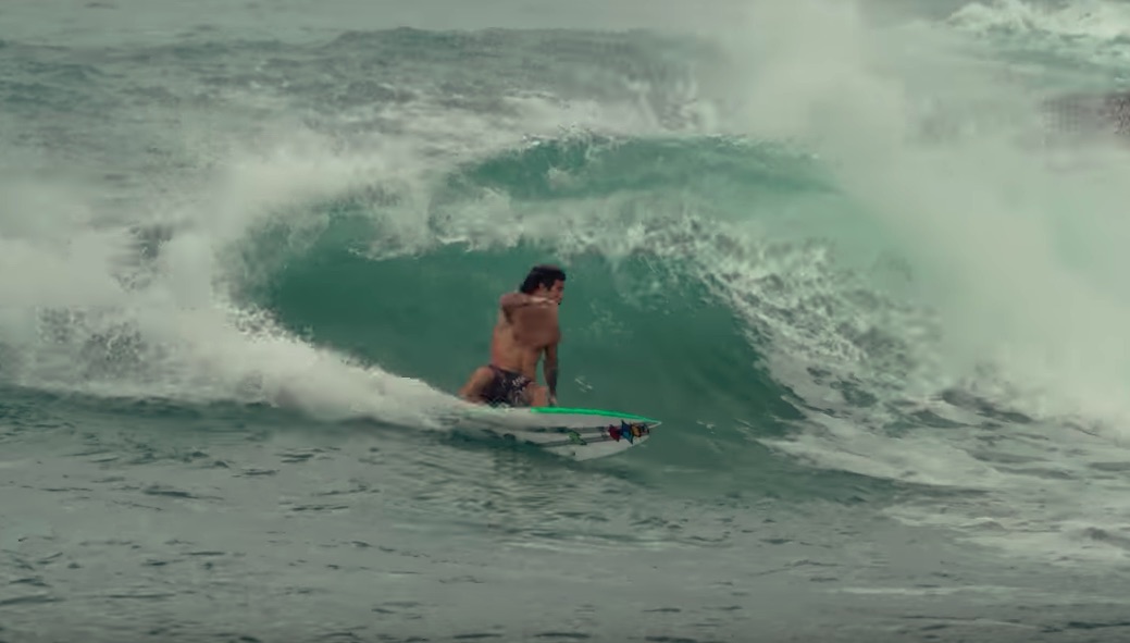 Surfer riding a wave in the ocean.