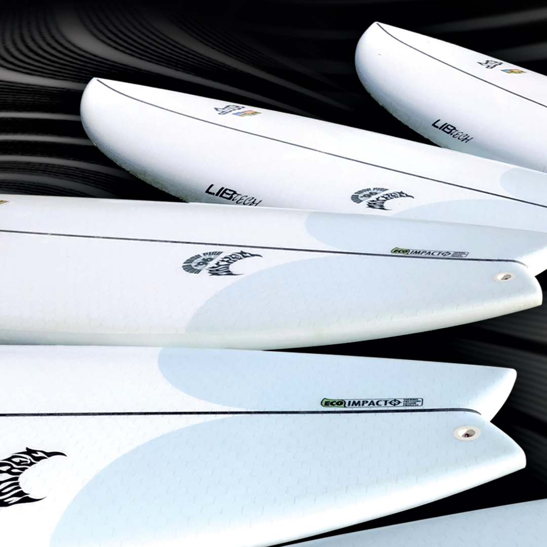 Four white surfboards are lined up against a dark, wavy background. Each board features different logos and designs, showcasing a sleek and modern look.