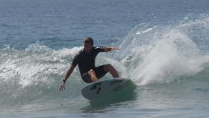 Surfer riding a wave on a surfboard.
